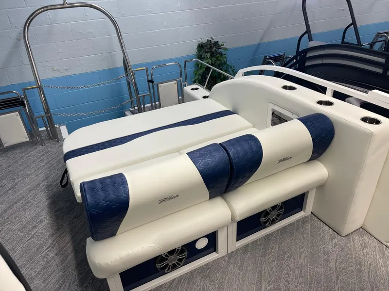 Slide: The Image of 2025 JC Swingback 25 TT boat interior with blue and white seating and cup holders. - 26