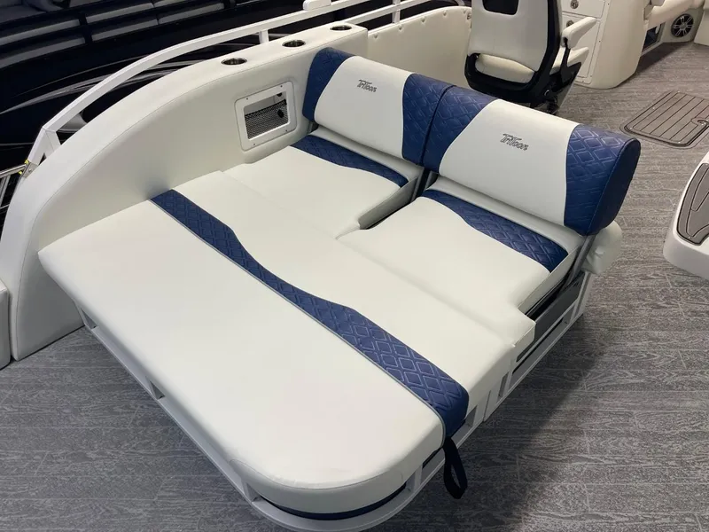 Slide: The Image of 2025 JC Swingback 25 TT boat interior with blue and white cushioned seating. - 27