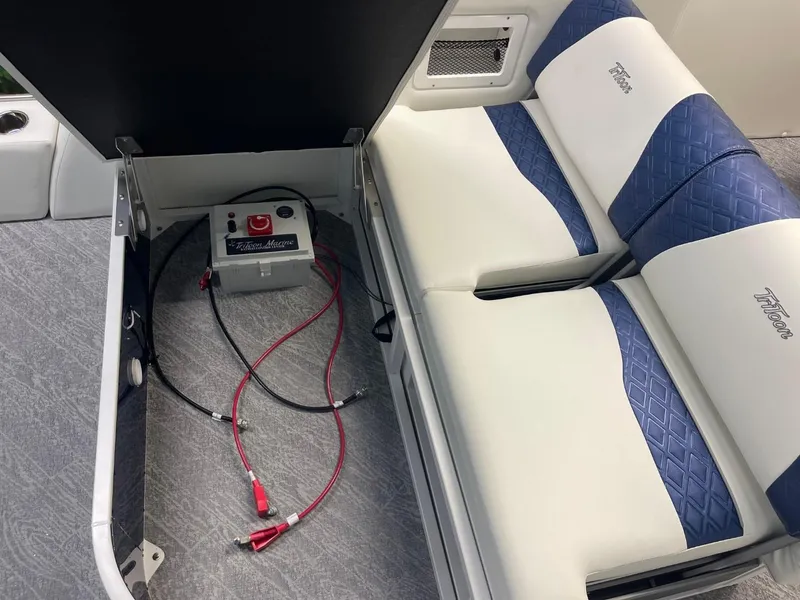Slide: The Image of 2025 JC Swingback 25 TT boat interior with battery compartment and cushioned seating. - 28