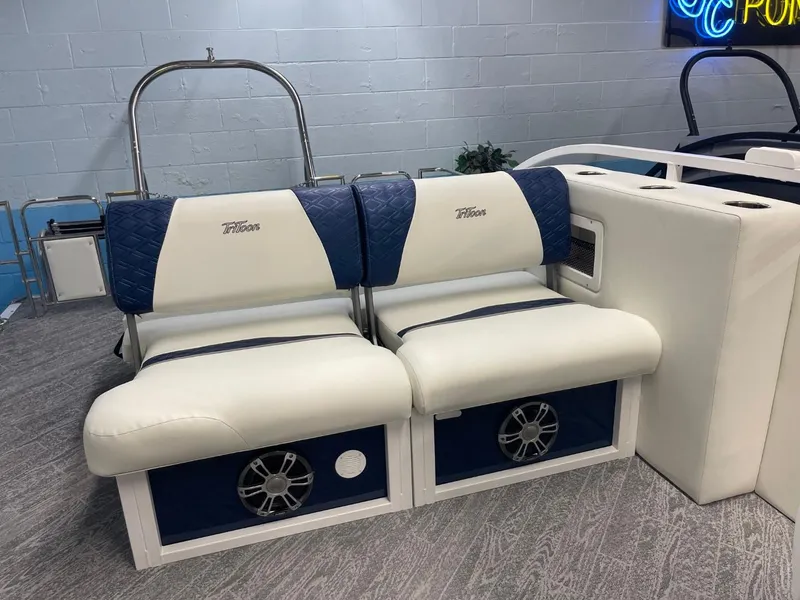 Slide: The Image of 2025 JC Swingback 25 TT boat seats with blue and white upholstery, featuring built-in speakers. - 29