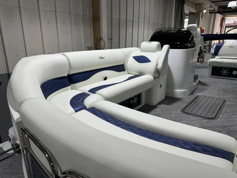 Slide: The Image of 2025 JC Swingback 25 TT boat interior with white and blue seating. - 3