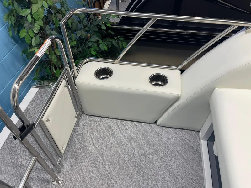 Slide: The Image of 2025 JC Swingback 25 TT boat interior with cup holders and railing. - 33
