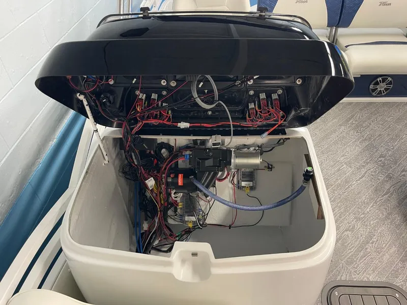 Slide: The Image of Open engine compartment of 2025 JC Swingback 25 TT boat, showing wiring and components. - 39