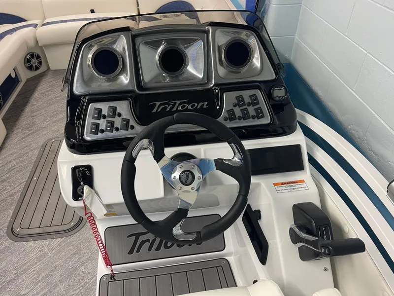 Slide: The Image of 2025 JC Swingback 25 TT boat dashboard with steering wheel and controls. - 40