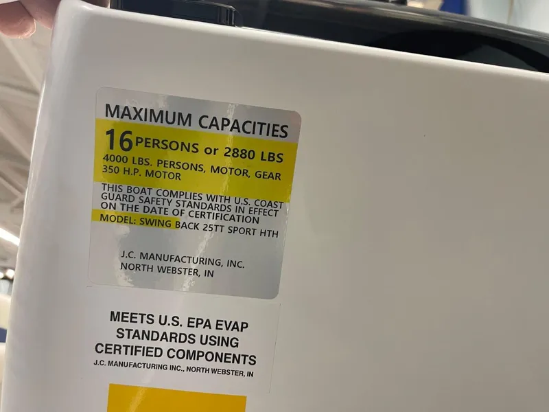 Slide: The Image of Capacity label on JC Swingback 25 TT boat, 2025 model, showing weight and passenger limits. - 42