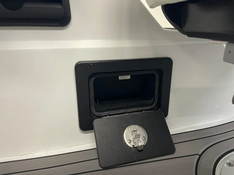 Slide: The Image of 2025 JC Swingback 25 TT storage compartment with open hatch and latch. - 44