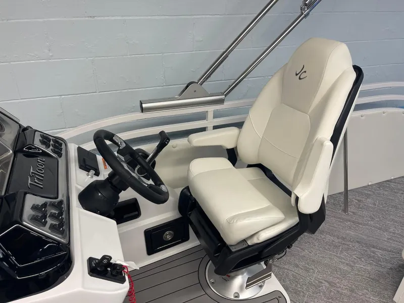 Slide: The Image of 2025 JC Swingback 25 TT boat helm with white captain's chair and steering wheel. - 49