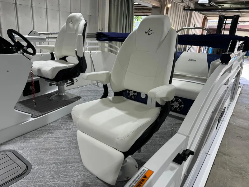Slide: The Image of 2025 JC Swingback 25 TT boat interior with white captain chairs and modern design. - 5