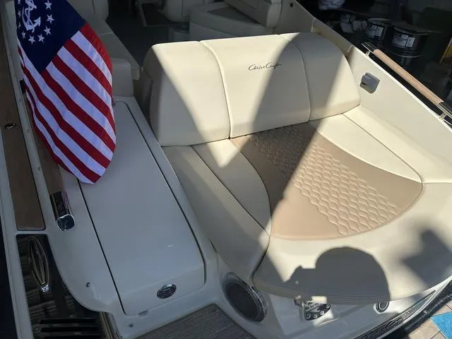 Slide: The Image of 2025 Chris-Craft Launch 28 GT boat interior with American flag and beige seating. - 4