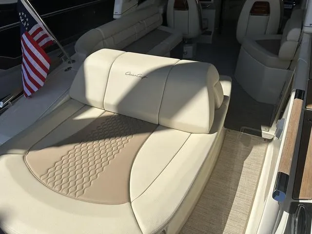 Slide: The Image of 2025 Chris-Craft Launch 28 GT interior with luxurious beige seating and American flag. - 5