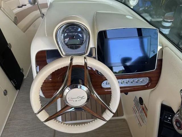 Slide: The Image of 2025 Chris-Craft Launch 28 GT dashboard with steering wheel and digital display. - 9