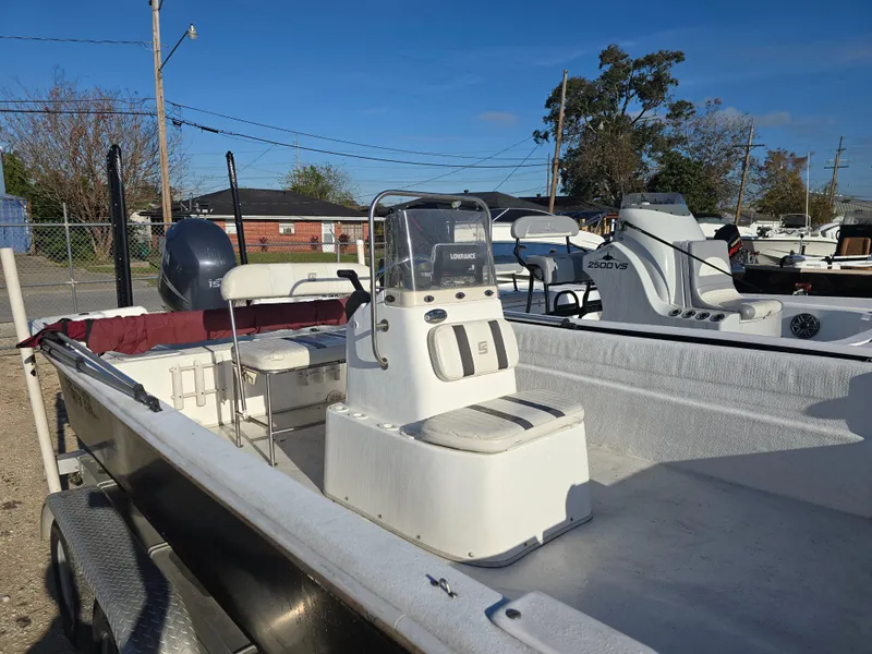 Slide: The Image of 2011 Carolina Skiff 218 DLV boat with center console and Yamaha outboard motor. - 10