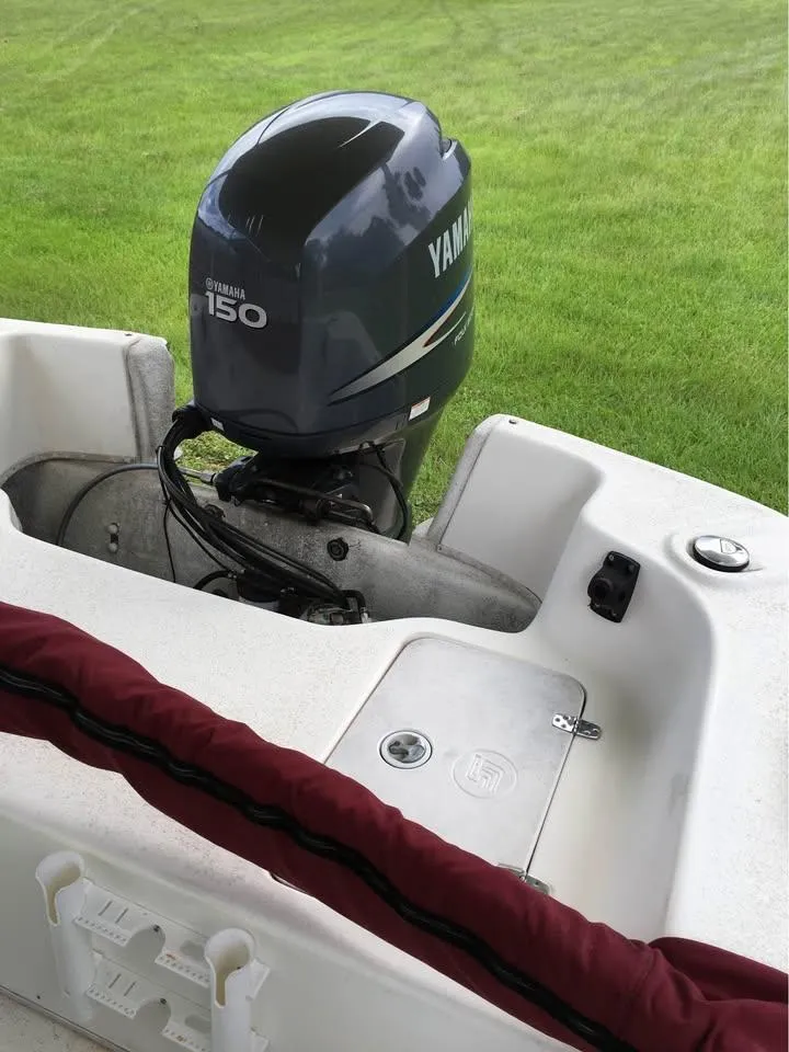 Slide: The Image of 2011 Carolina Skiff 218 DLV with Yamaha 150 engine on grassy background. - 14
