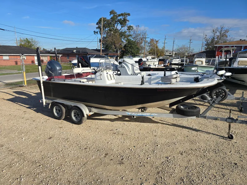 Slide: The Image of 2011 Carolina Skiff 218 DLV boat on trailer in outdoor lot. - 2