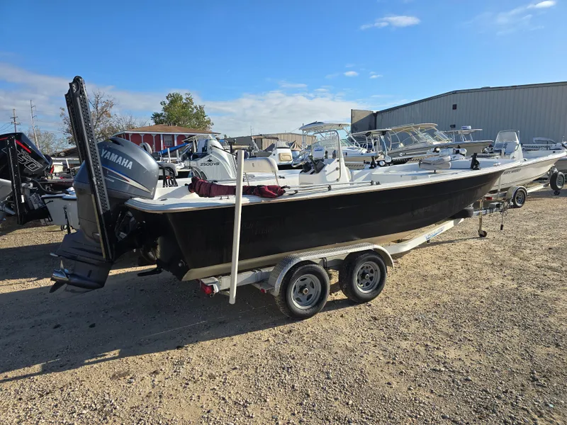 Slide: The Image of 2011 Carolina Skiff 218 DLV boat on trailer with Yamaha outboard motor. - 4