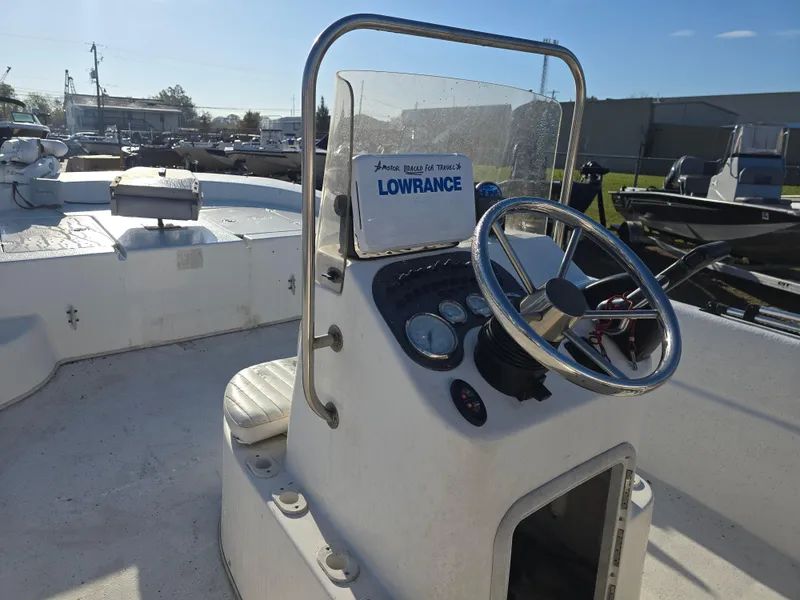 Slide: The Image of 2011 Carolina Skiff 218 DLV boat console with steering wheel and Lowrance navigation system. - 8