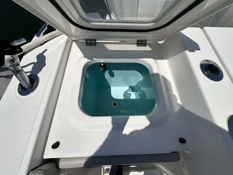 Slide: The Image of Open hatch on 2021 Pursuit S 428 Sport boat, revealing storage compartment. - 10