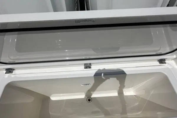 Slide: The Image of Open storage compartment of 2021 Pursuit S 428 Sport boat. - 16
