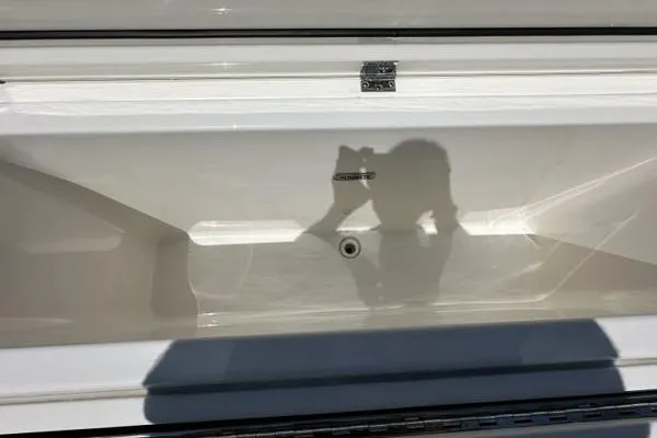 Slide: The Image of Open storage compartment on 2021 Pursuit S 428 Sport boat. - 17