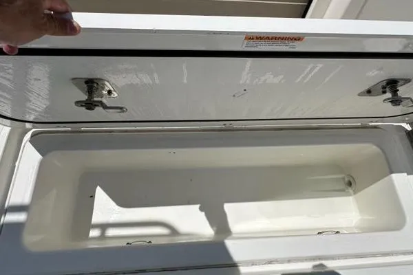 Slide: The Image of Open storage compartment on 2021 Pursuit S 428 Sport boat. - 20