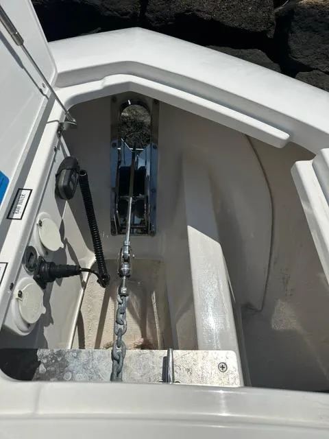 Slide: The Image of 2021 Pursuit S 428 Sport anchor compartment with chain and controls. - 24
