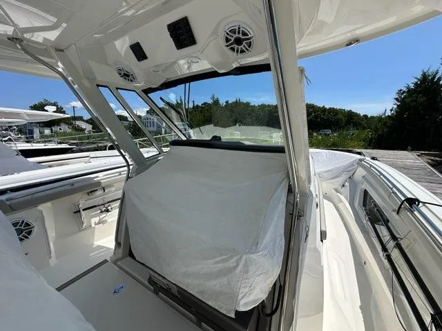Slide: The Image of 2021 Pursuit S 428 Sport boat interior with covered seating and modern design. - 26