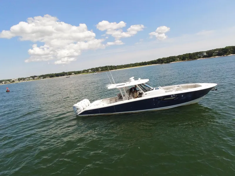 Slide: The Image of 2021 Pursuit S 428 Sport boat cruising on a sunny day. - 3