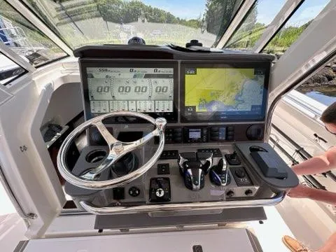 Slide: The Image of 2021 Pursuit S 428 Sport boat dashboard with navigation screens and controls. - 33