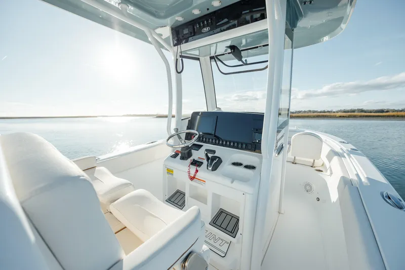 Slide: The Image of 2021 Sea Hunt Ultra 255 SE boat interior with helm and seating. - 16