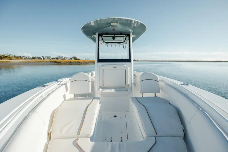 Slide: The Image of 2021 Sea Hunt Ultra 255 SE boat interior on calm water. - 21