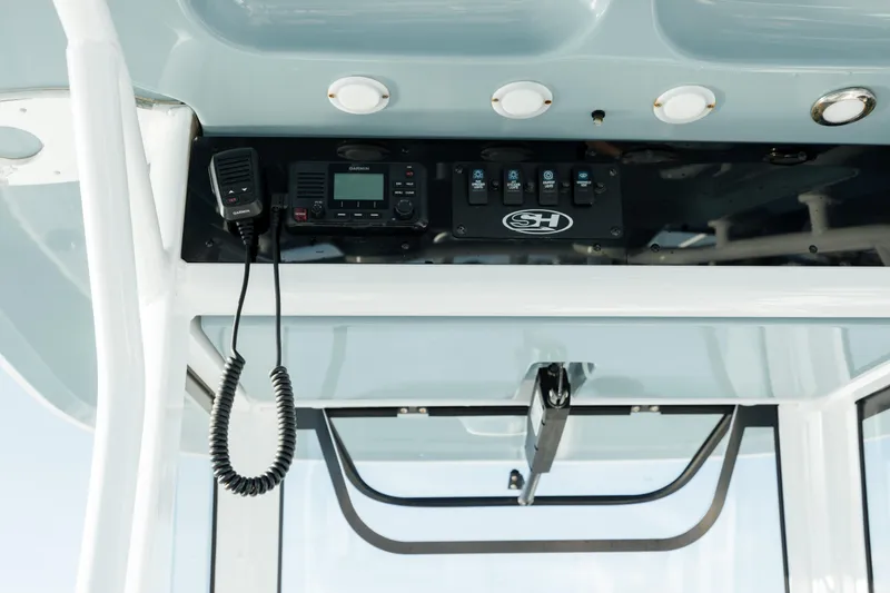 Slide: The Image of 2021 Sea Hunt Ultra 255 SE boat console with radio and controls. - 25