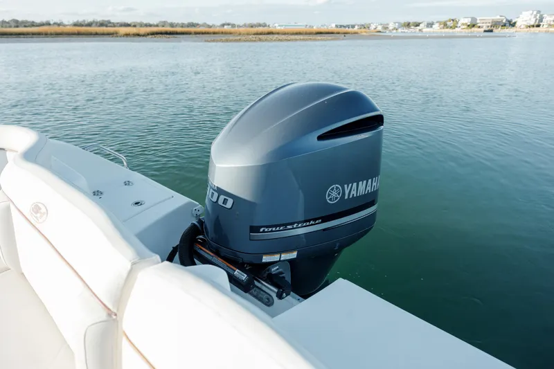 Slide: The Image of 2021 Sea Hunt Ultra 255 SE with Yamaha outboard motor on calm water. - 8