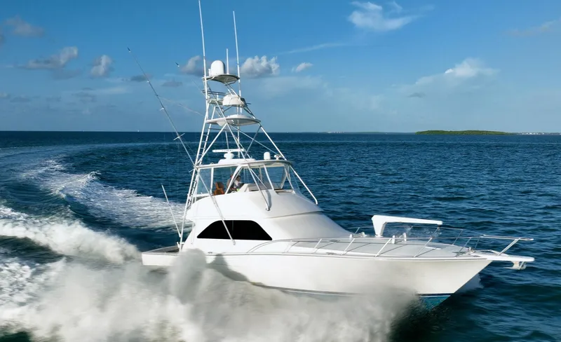 Slide: The Image of 2005 Viking 48 Convertible yacht cruising on open ocean waters. - 34