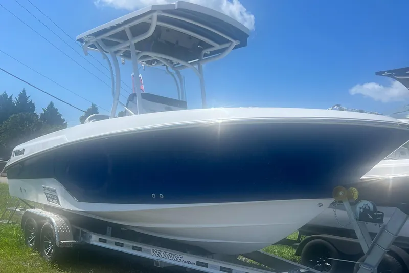 The Image of 2023 Wellcraft 222 Fisherman boat on trailer under blue sky. - 0