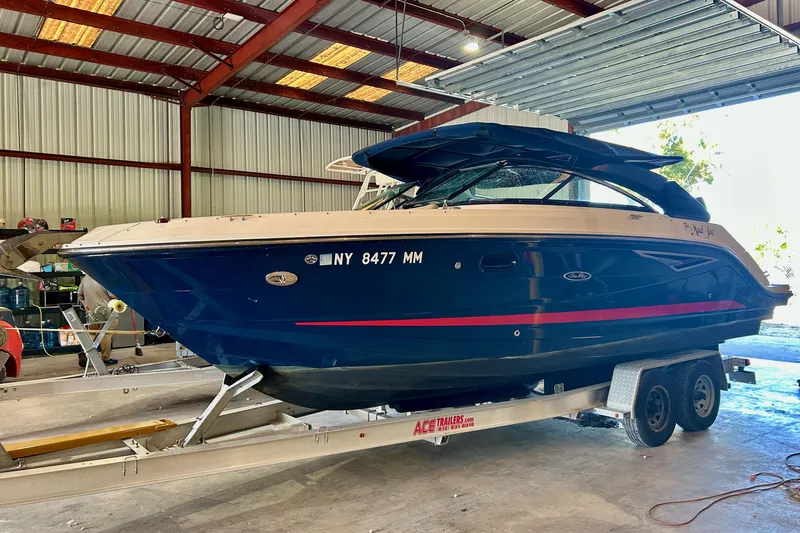 Slide: The Image of 2018 Sea Ray SLX 250 boat on trailer in a storage facility. - 1