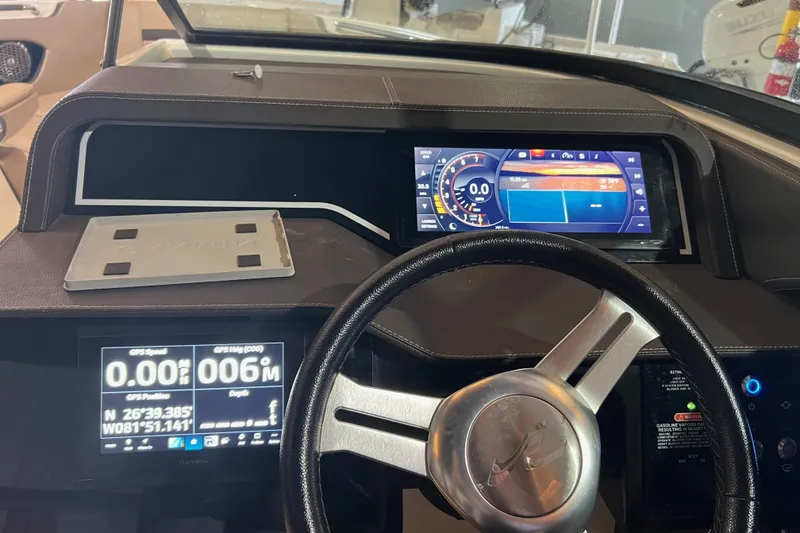 Slide: The Image of Dashboard of 2018 Sea Ray SLX 250 boat with digital displays and steering wheel. - 11