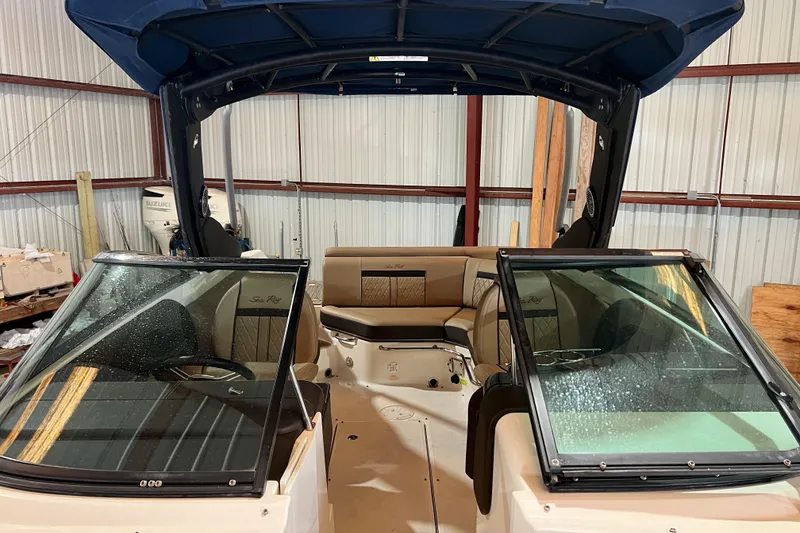 Slide: The Image of 2018 Sea Ray SLX 250 boat interior with open windshield in storage. - 3