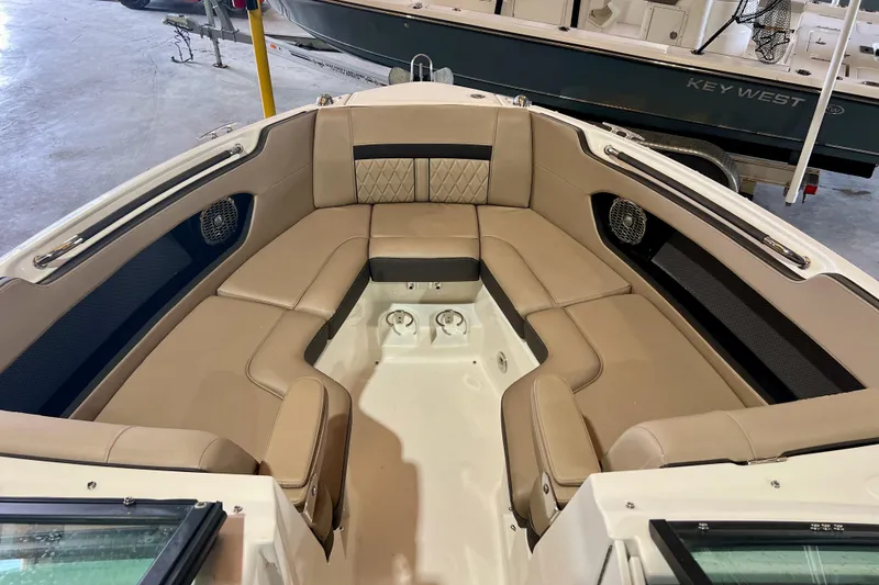 Slide: The Image of 2018 Sea Ray SLX 250 boat interior with tan seating and modern design. - 4