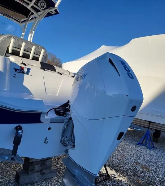 Slide: The Image of 2023 Wellcraft 222 Fisherman boat on trailer under blue sky. - 1