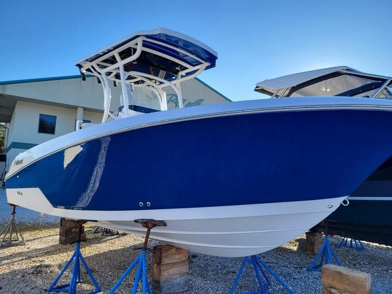 The Image of 2023 Wellcraft 242 Fisherman boat in vibrant blue on display. - 0