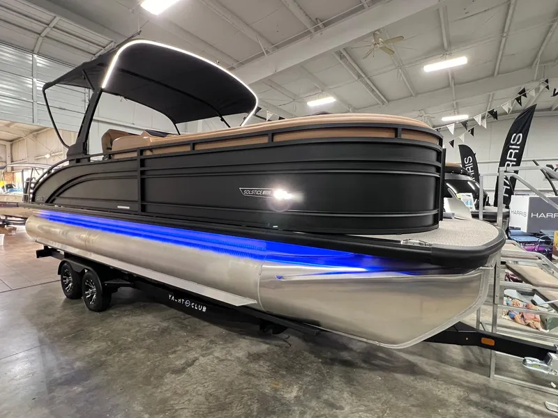 The Image of 2025 Harris Solstice 250 pontoon boat with blue LED lights in showroom. - 0
