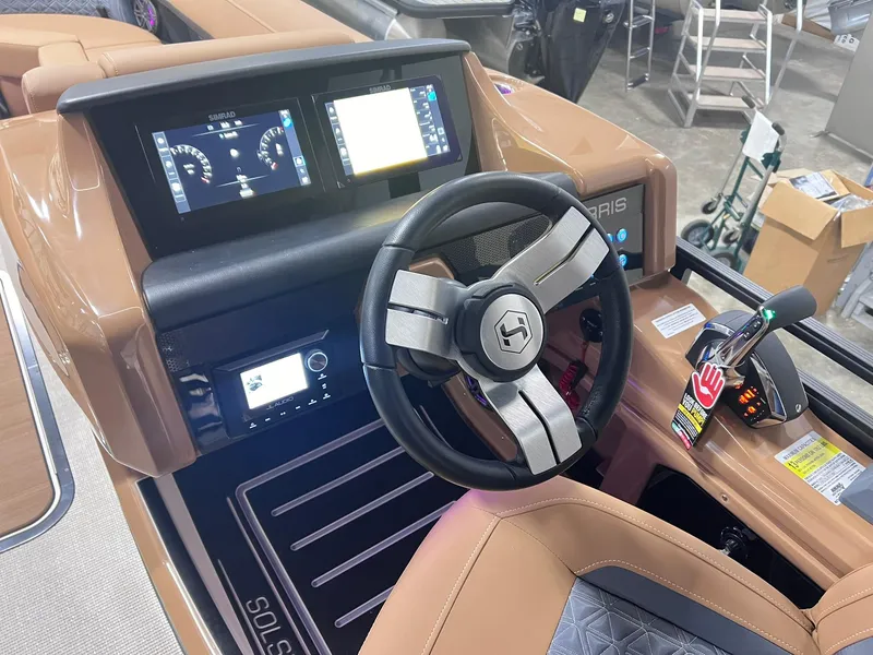 Slide: The Image of 2025 Harris Solstice 250 boat dashboard with steering wheel and digital displays. - 16