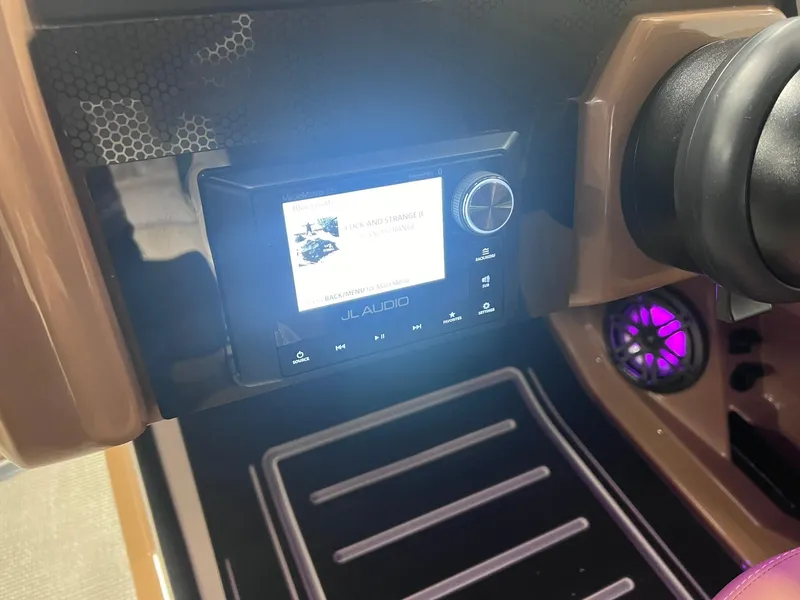 Slide: The Image of 2025 Harris Solstice 250 dashboard with JL Audio system and illuminated speaker. - 19