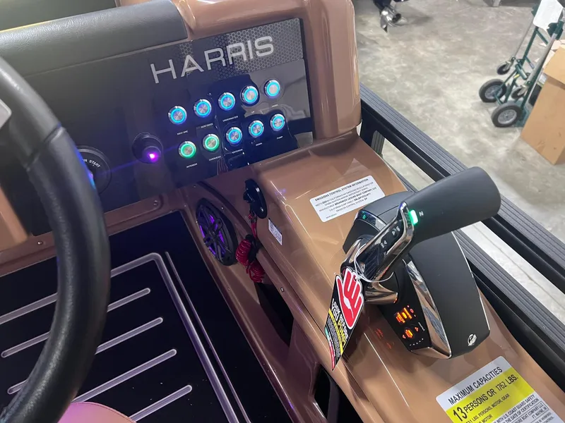 Slide: The Image of 2025 Harris Solstice 250 boat dashboard with illuminated controls and throttle lever. - 20