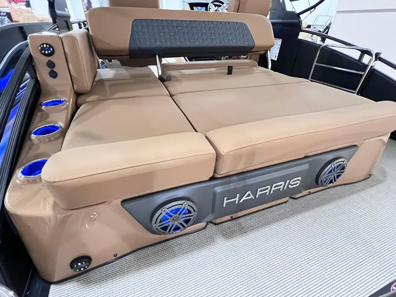 Slide: The Image of 2025 Harris Solstice 250 boat interior with tan seating and built-in speakers. - 23