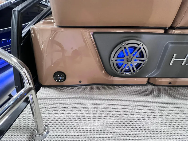 Slide: The Image of 2025 Harris Solstice 250 boat interior with speaker and beige seating. - 27
