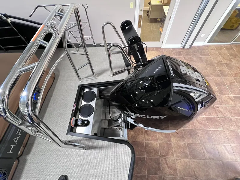 Slide: The Image of 2025 Harris Solstice 250 boat with Mercury engine, top view of deck and motor. - 28