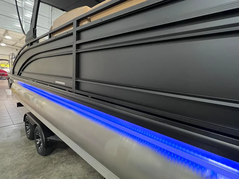 Slide: The Image of 2025 Harris Solstice 250 pontoon boat with sleek design and vibrant blue LED lighting. - 30