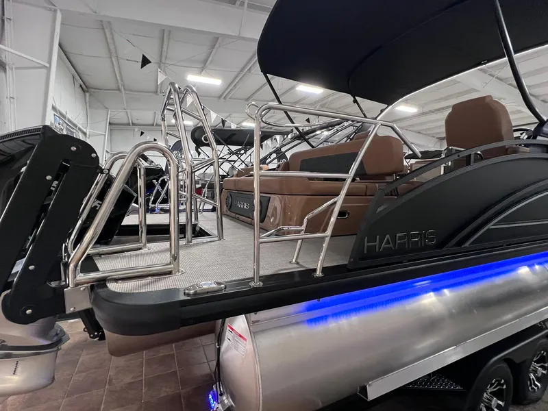 Slide: The Image of 2025 Harris Solstice 250 pontoon boat with sleek design and modern features in showroom. - 32