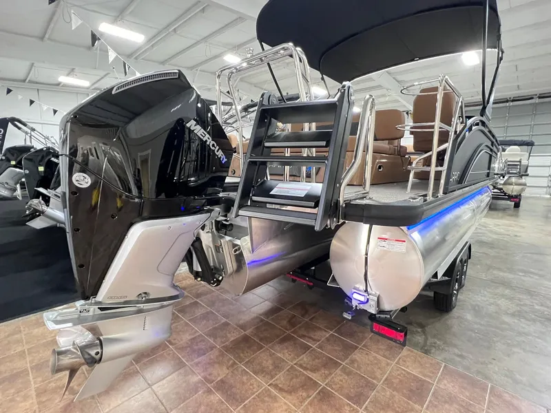 Slide: The Image of 2025 Harris Solstice 250 pontoon boat with Mercury engine in showroom. - 33